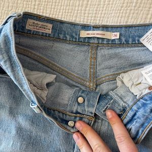 Levi’s Ribcage size 26 w/ big holes & small stain